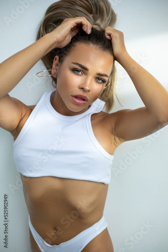 Portrait of sexy young woman in white tank top..