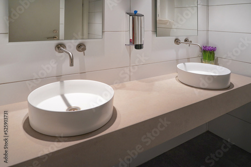 Interior of bathroom with washbasin and faucet. Public bathroom in the airport or restaurant, cafe, office. Bathroom interior sink with modern design in hotel