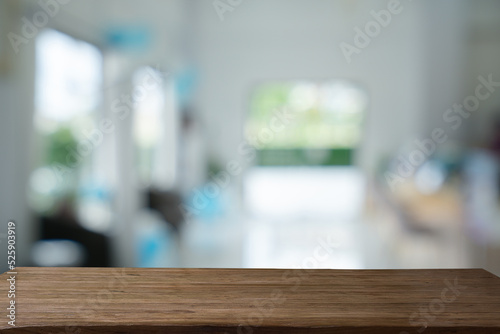 Abstract bokeh in cafe background of nature in green color with Steel black table.