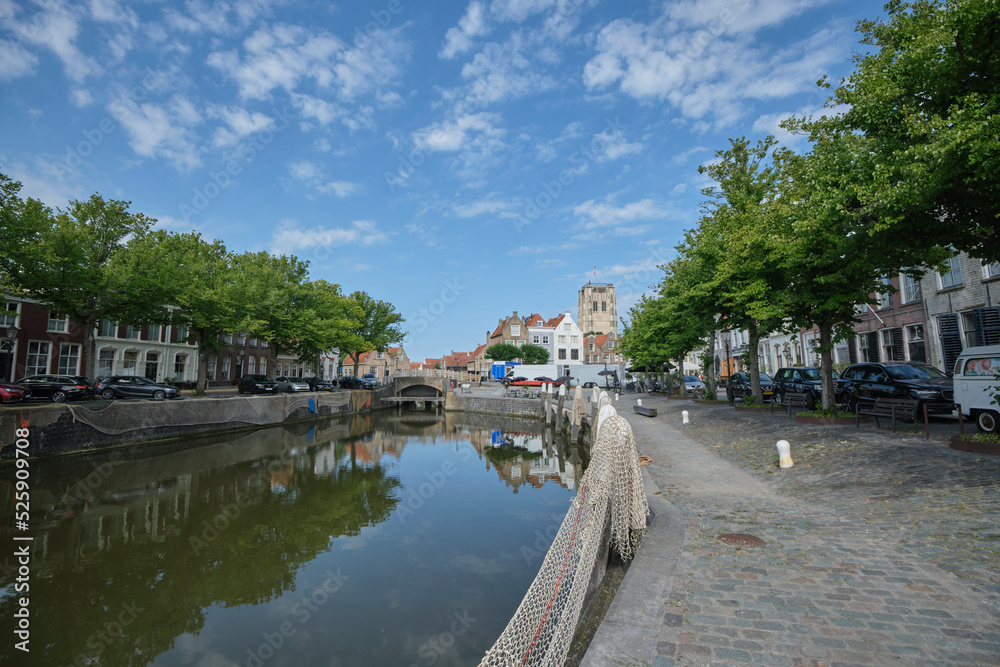 Goedereede, The Netherlands. Small harbor in the picturesque medieval town of Goedereede overlooking a beautiful old Gothic church tower that was used as a lighthouse at the time.