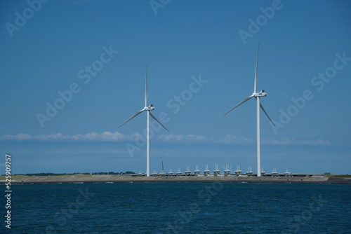 View of Neeltje Jans flood barrier with wind turbines photo