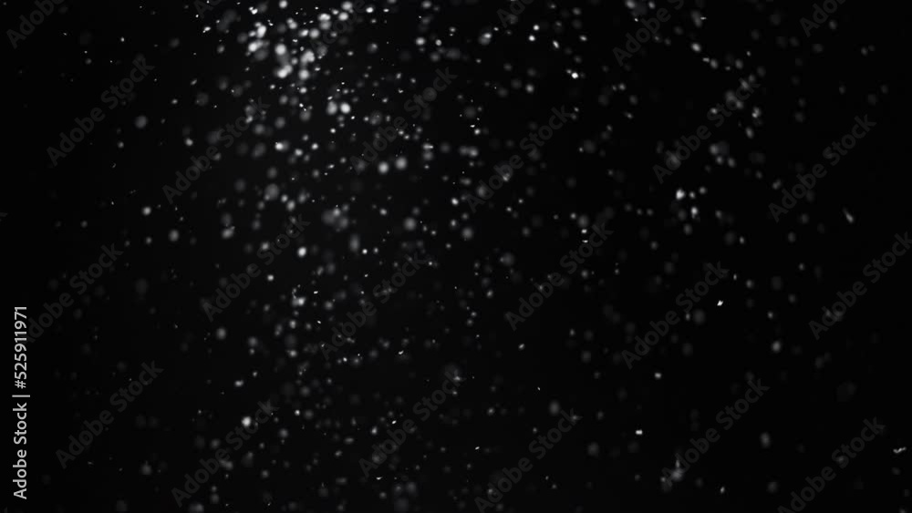 Blur snow texture. Night snowfall. Winter blizzard. Defocused white powder particles falling on dark black abstract background for intro.