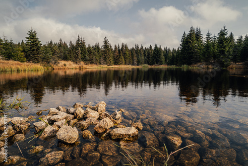 View of a scandinavian like mountain lake in autumn. Landscape in fall, small lake with rocks on the bank.