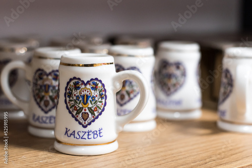 Small beer mugs with folklore symbols, a souvenir from Kashubia. photo