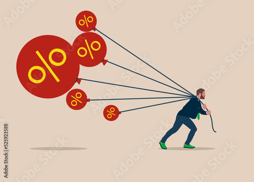 Businessman tries to pull down many inflation balloons. Reserve try to tame inflation down by interest rate hike. Stop inflation, Inflation bubble.  photo