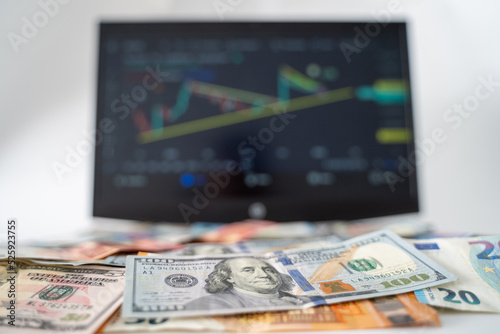 Stock Market Chart on Screen with Dollars and Euros on Background