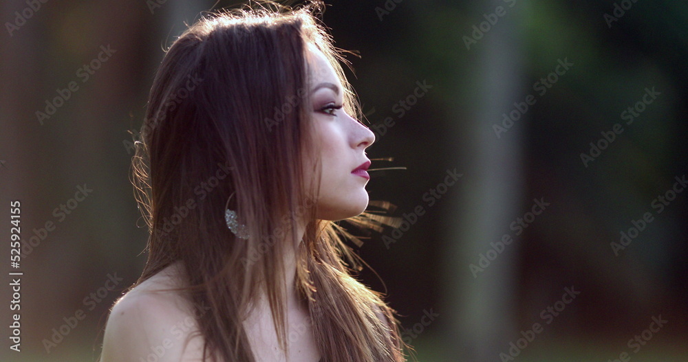 Contemplative thoughtful young woman thinking about life at park. Pensive millennial girl staring melancholically Contemplative thoughtful young woman thinking about life at park. Pensive millennial girl staring melancholically