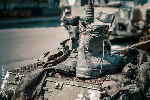 Photography Fragments of burnt shoes and clothes of Russian soldiers on wrecked armored vehi