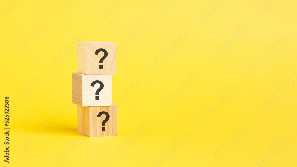 question mark shown on three wooden cubes on a yellow background question mark shown on three wooden cubes on a yellow background