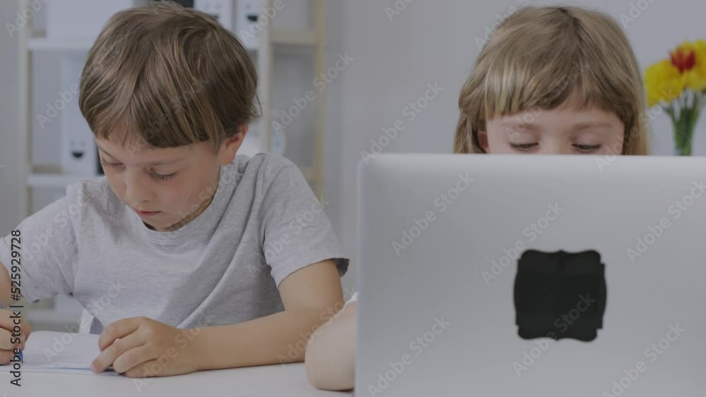 Brother helps his younger sister to make her homework. Brother helps his younger sister to make her homework.
