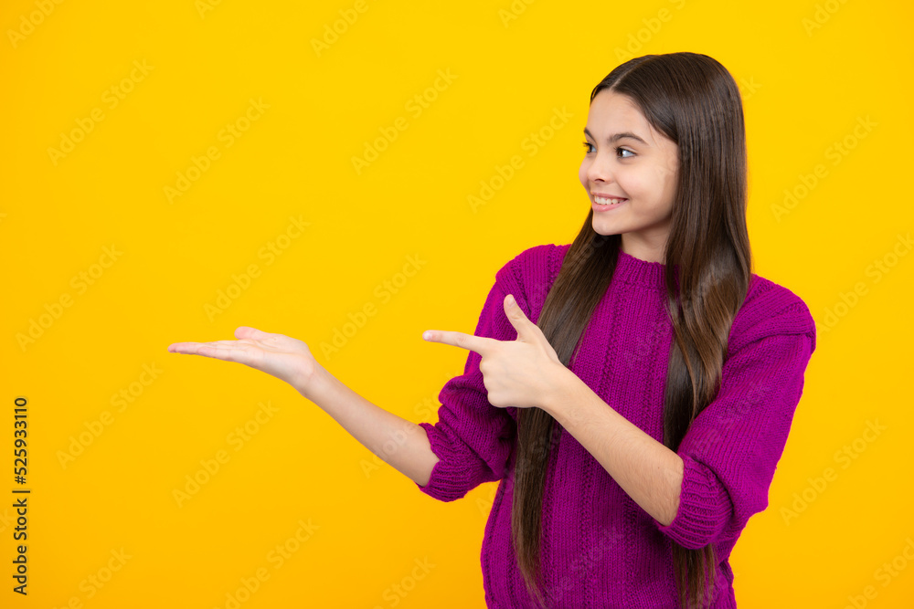 Impressed teenage girl showing recommendation copyspace. Child teenager points away, pointing aside at copy space. Impressed teenage girl showing recommendation copyspace. Child teenager points away, pointing aside at copy space.