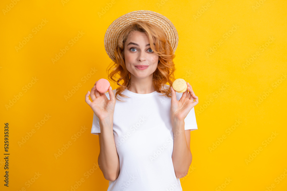 Young woman eating delicious macaroon on yellow background. Girl eat the macaron. Young woman eating delicious macaroon on yellow background. Girl eat the macaron.