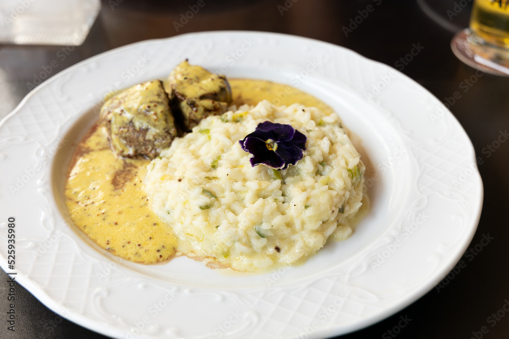Filet mignon with mustard sauce served with a delicious Italian risotto. Filet mignon with mustard sauce served with a delicious Italian risotto.
