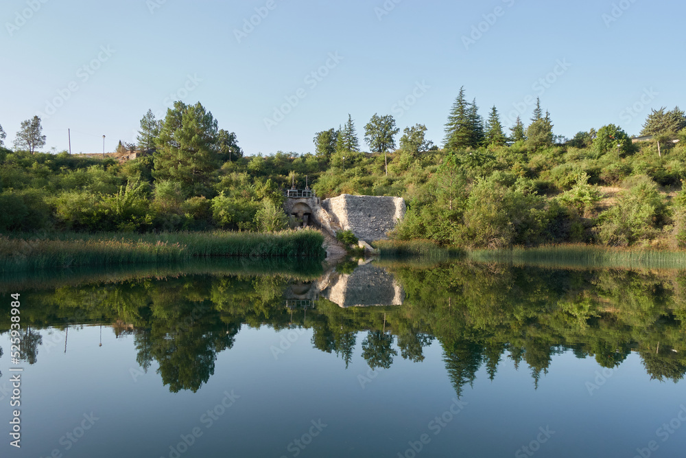 reflection of an old dam in the lagoon