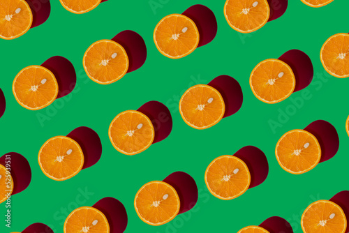 Orange pattern on a green background. Pop art design, creative citruses. Yellow lemon, minimal flat style.