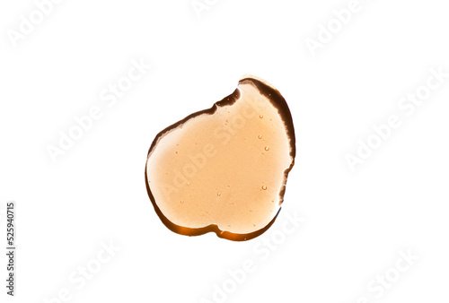 Orange cosmetics gel, serum or peeling drop isolated on white background. Oily slime with air bubbles in the sunlight. High contrast trendy beauty pattern. Health protection and self-care concept.