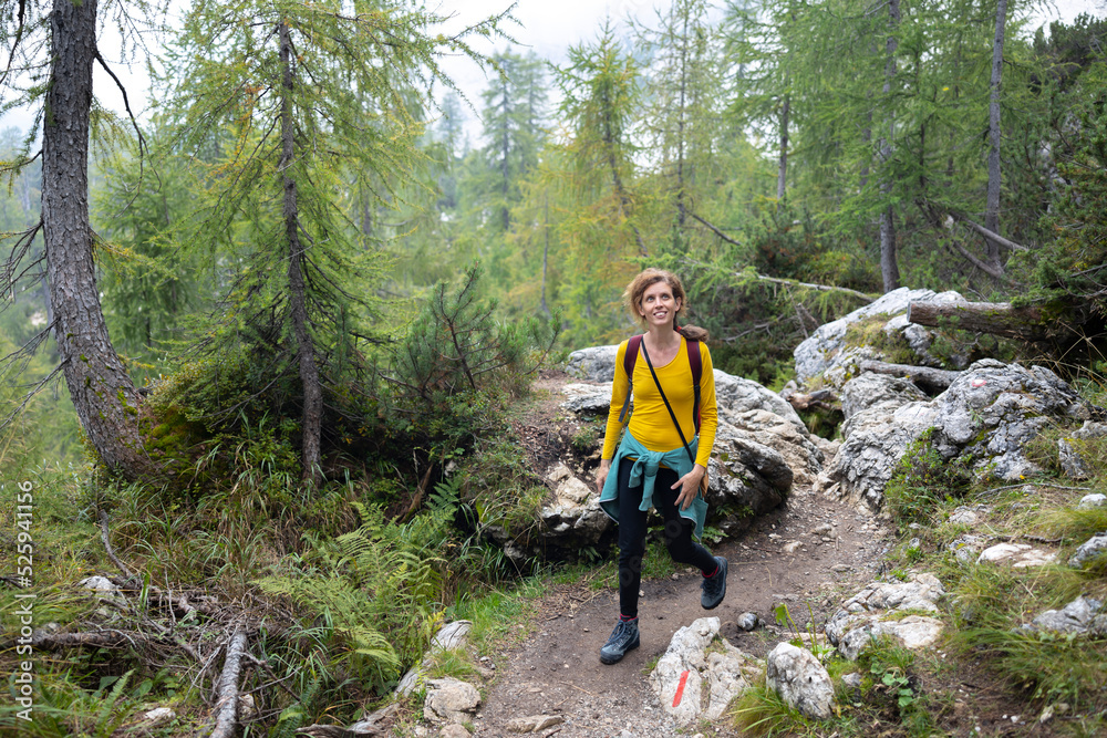 Obraz premium Mid Adult Woman hiking alone in Mountains