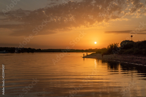 Beautiful bright dramatic sunset over the river