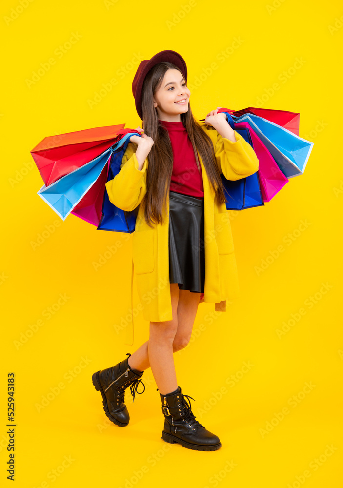 Happy teenager portrait. Funny teen girl hold shopping bag enjoying sale isolated on yellow. Portrait of teenager schoolgirl is ready to go shopping. Smiling girl. Happy teenager portrait. Funny teen girl hold shopping bag enjoying sale isolated on yellow. Portrait of teenager schoolgirl is ready to go shopping. Smiling girl.
