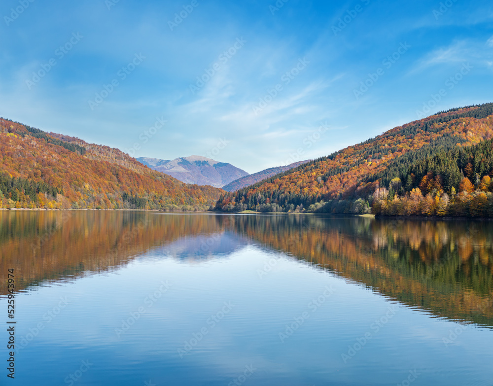 Vilshany water reservoir on the Tereblya river, Transcarpathia, Ukraine. Picturesque lake with clouds reflection. Beautiful autumn day in Carpathian Mountains.