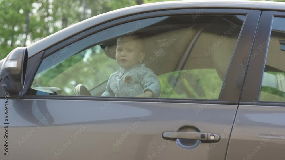 lonely crying baby child left alone inside locked car, waiting mother parents return come back. cruelty violence on baby kid toddler. bad parents concept abuse childhood. call for help trapped in baby lonely crying baby child left alone inside locked car, waiting mother parents return come back. cruelty violence on baby kid toddler. bad parents concept abuse childhood. call for help trapped in baby