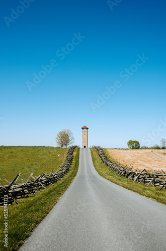 A fence lined road through fields at Antietam Battlefield, Maryland