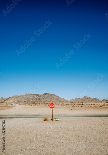 Stop sign in barren rural dry desert landscape, California photo
