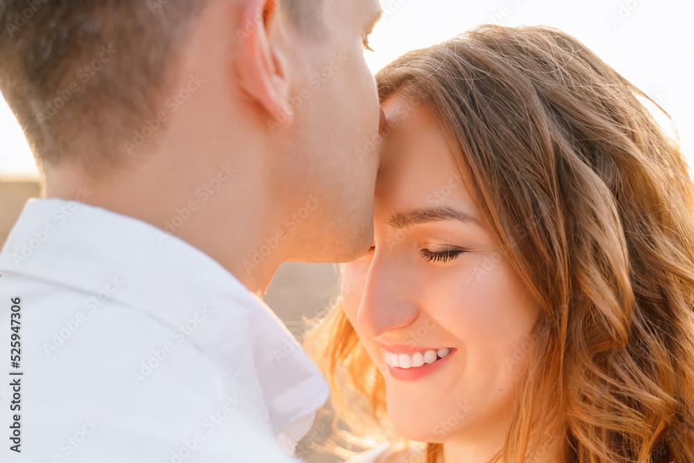 Young family lovers couple hugging on the beach at sunset time, Young family lovers couple hugging on the beach at sunset time,