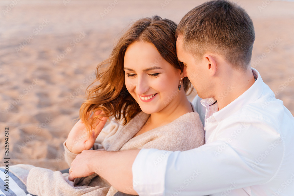 Young family lovers couple hugging on the beach at sunset time, Young family lovers couple hugging on the beach at sunset time,