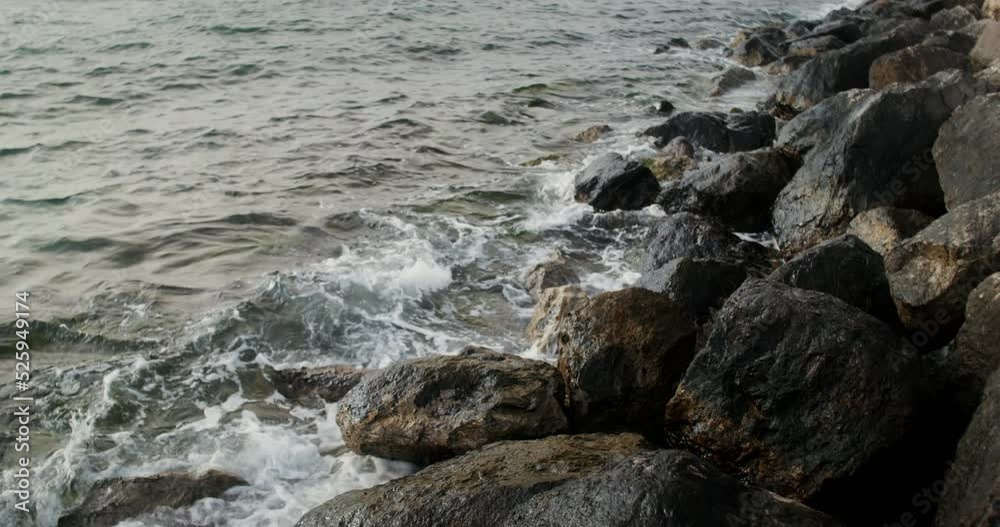 Sea waves hit large rocks on the coast, foaming and splashing as they wash over the boulders. 4k video, red komodo Sea waves hit large rocks on the coast, foaming and splashing as they wash over the boulders. 4k video, red komodo