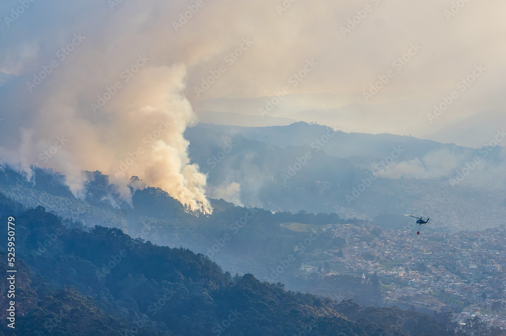 Firefighting helicopter heading towards foreest fire in Bogota, Colombia