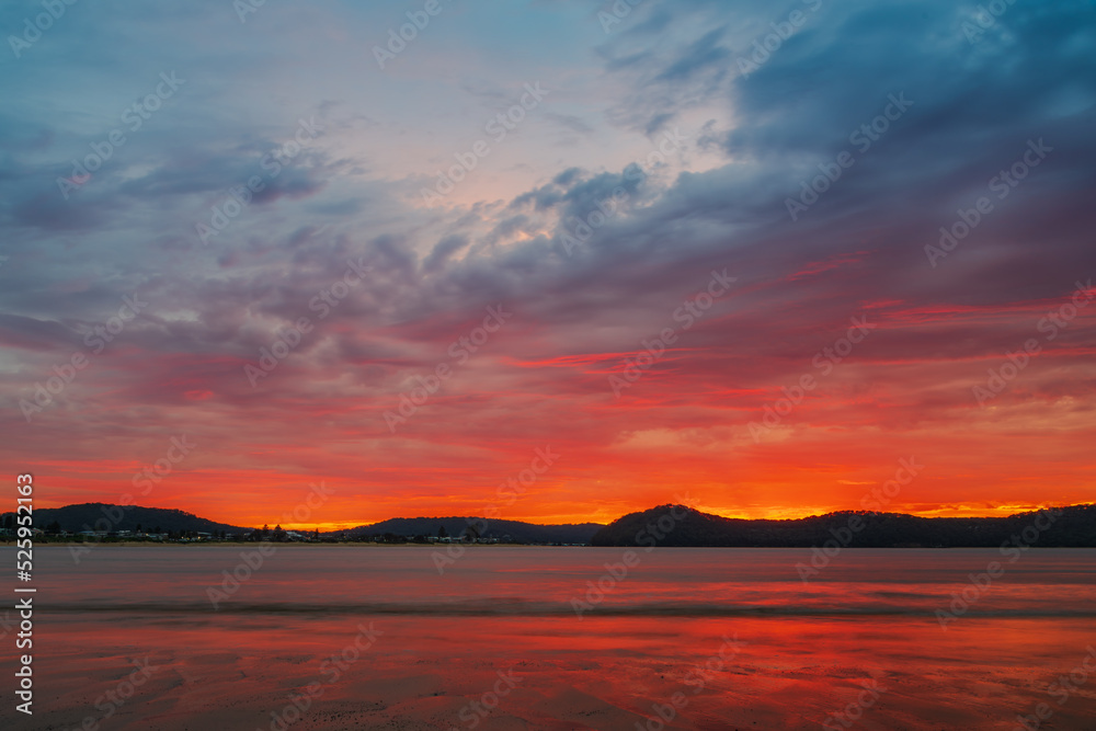 Colourful cloud filled sunrise at the seaside