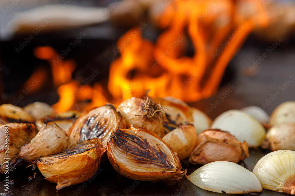 Onions cooked on the grill are on the grill.