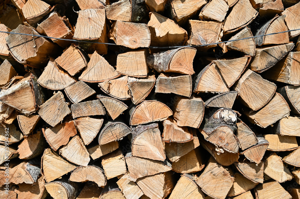 Chopped and stacked firewood. Logs of firewood stacked in boxes. Stock for winter. Chopped and stacked firewood. Logs of firewood stacked in boxes. Stock for winter.