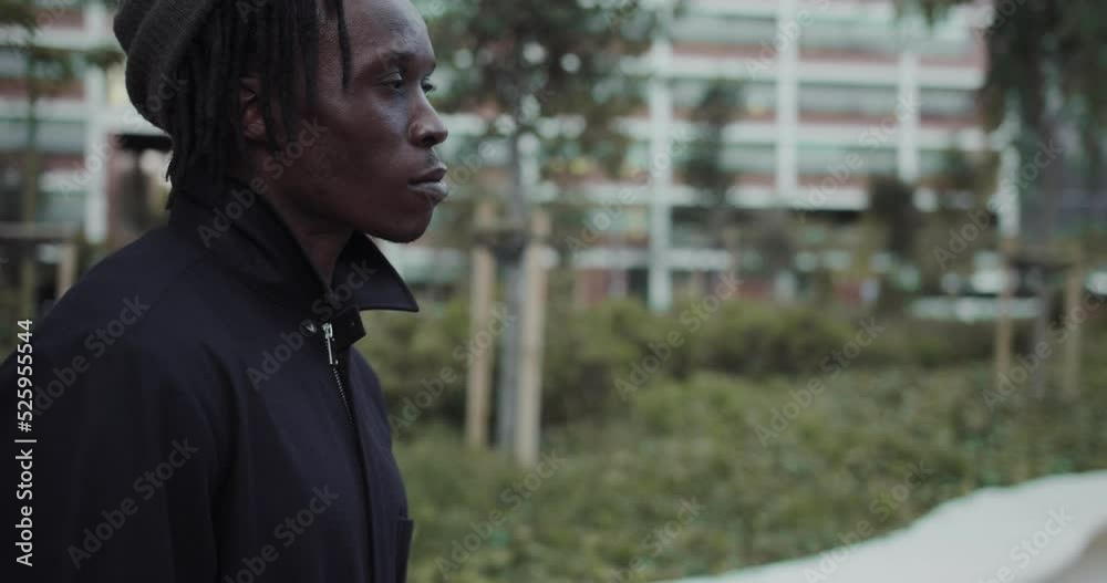 Portrait young african american man standing near the office building and looking at camera. Handsome dark-skinned guy on the street Portrait young african american man standing near the office building and looking at camera. Handsome dark-skinned guy on the street