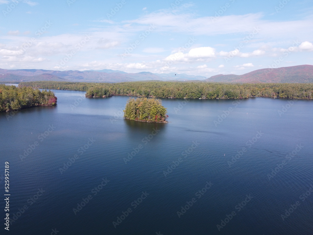 Islands on Squam Lake in New Hampshire during fall with changing leaves