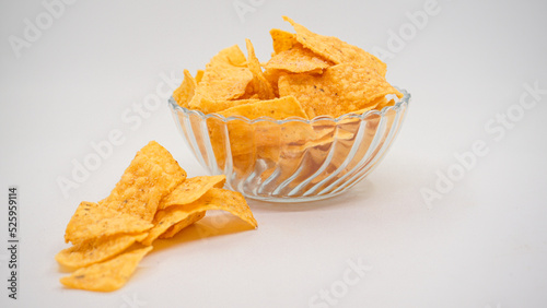 Delicious nachos chips on the glass bowl, isolated on white background