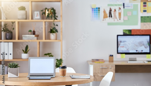 Empty business office interior with a laptop and computer on a desk or table with a professional design. An agency workspace or workplace with equipment connected to the internet or company wifi © Sanele G/peopleimages.com