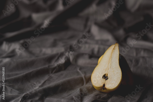Minimal shot of cut pear on linen tablecloth