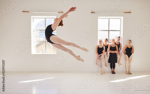 Fototapete Dance studio, ballet and jump in air while class watches girl student move with agility and grace