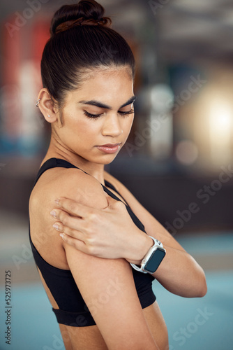 Injury  hurt and shoulder pain for a female athlete holding her painful arm at the gym. Active  fit and athletic woman suffering from muscle inflammation due to an exercise or workout