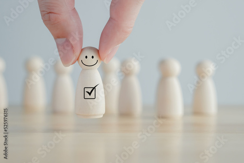 Photos Hand pick happy face wooden figure