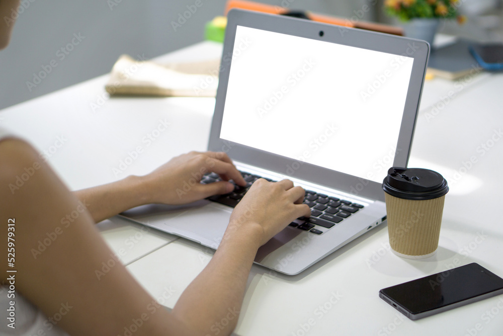 Back view of businesswoman sit at desk in office typing on laptop computer keyboard with white screen. Back view of businesswoman sit at desk in office typing on laptop computer keyboard with white screen.