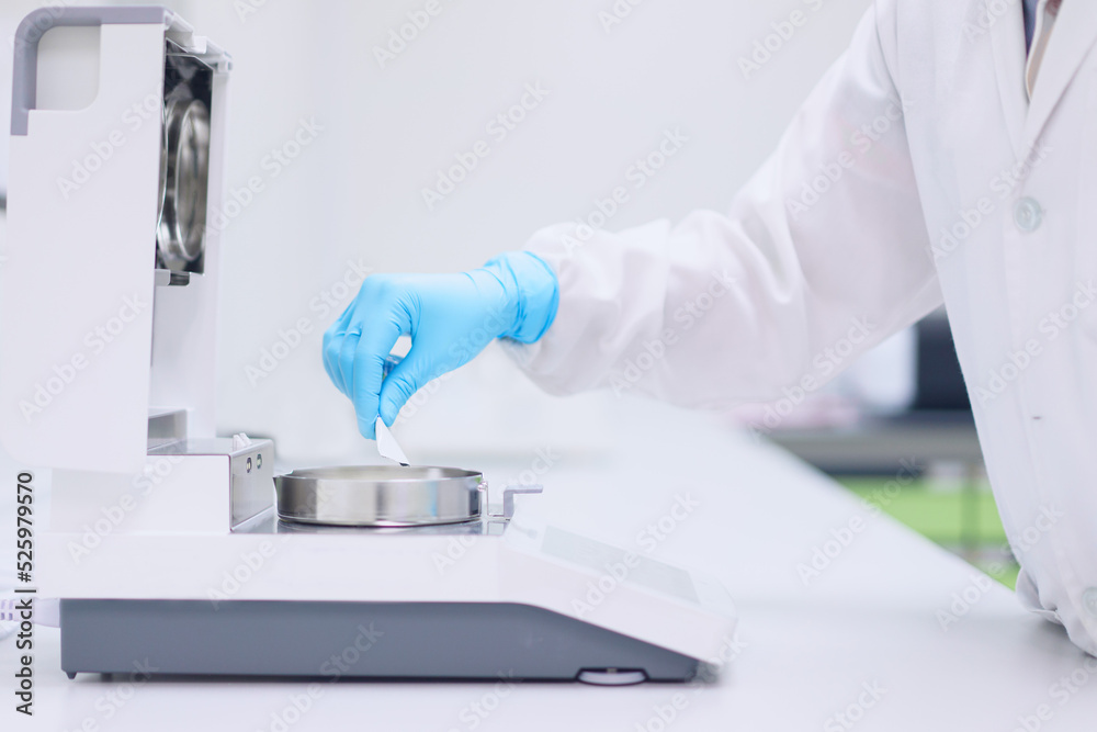 Operator Laboratory Unidentified operator or chemist is testing moisture or water content ...