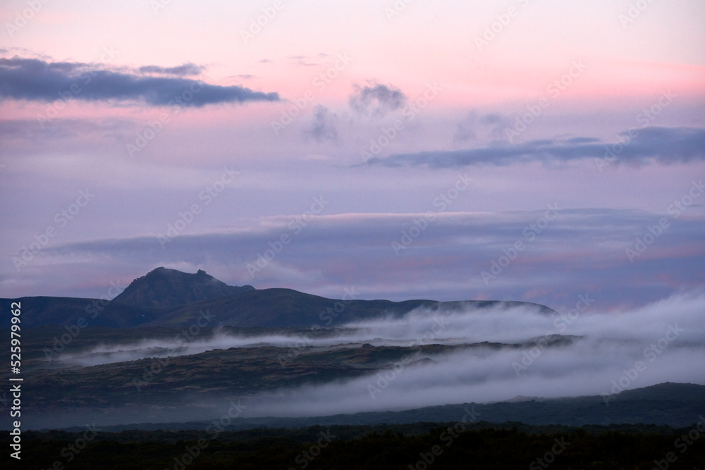 Rocky mountains under scenic pink sundown sky Rocky mountains under scenic pink sundown sky