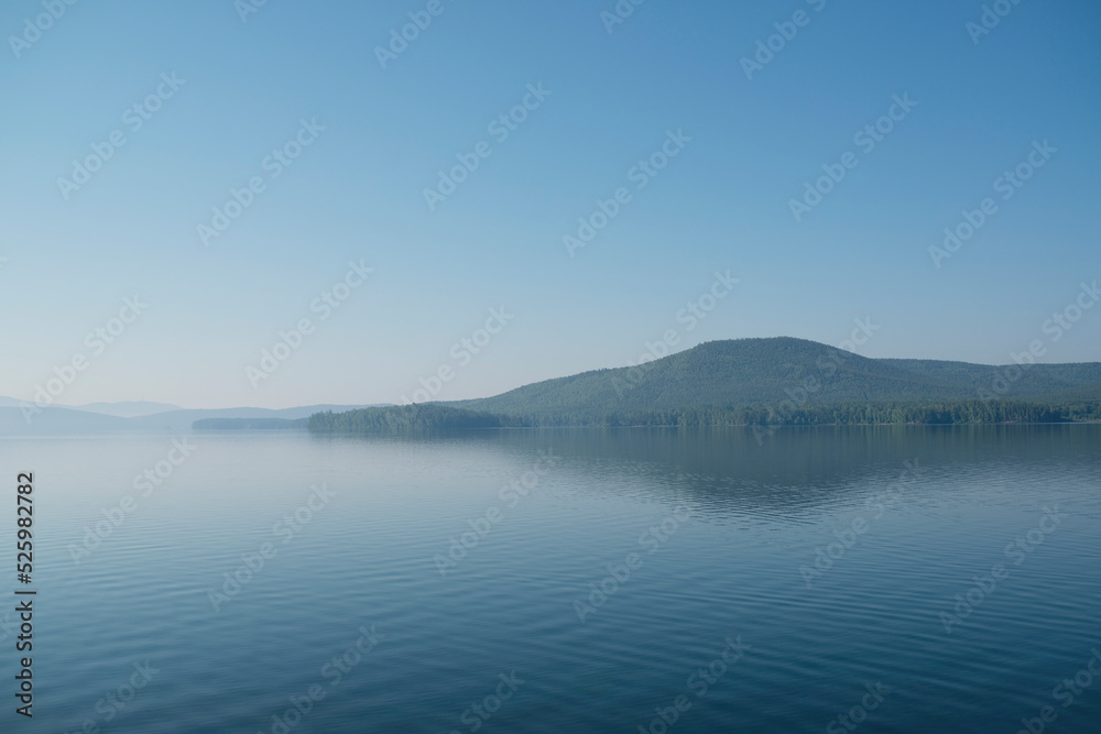 The landscape of a beautiful blue lake in summer on a sunny day