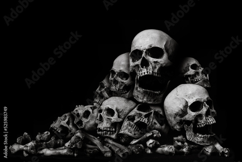 Awesome pile of skull human and bone on black cloth background, concept of scary crime scene of horror or thriller movies,Halloween theme, Still Life style, selective focus,