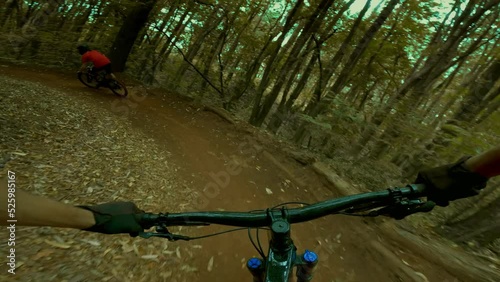 Mountain biking extreme POV down forest trail 