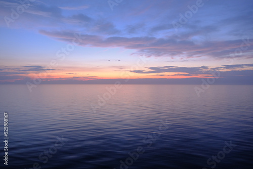 View from open outdoor deck of legendary luxury ocean liner cruise ship on passage during Transatlantic Crossing from Southampton to New York with deck chairs, railing and superstructure