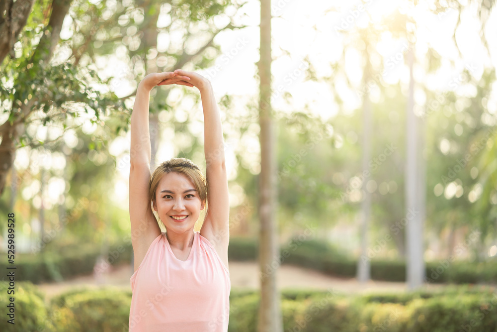 Attractive young Asian woman happy smile healthy lifestyle in sportswear stretching or warm up for exercise in park outdoor under sunset. Healthy lifestyle and relaxation. Attractive young Asian woman happy smile healthy lifestyle in sportswear stretching or warm up for exercise in park outdoor under sunset. Healthy lifestyle and relaxation.